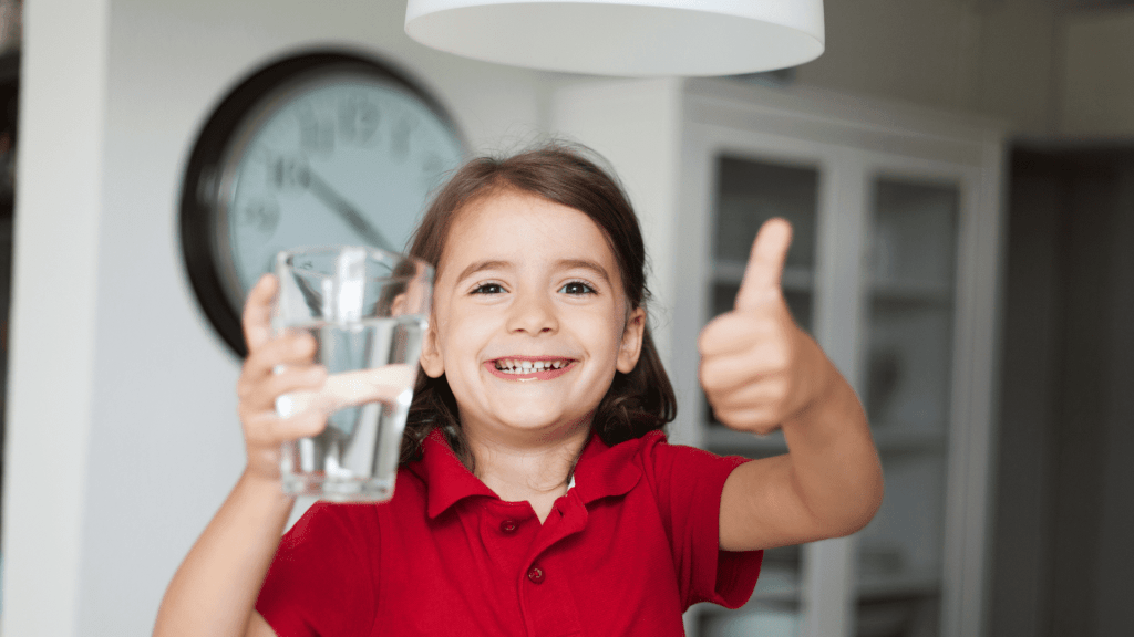Kid drinking water happily