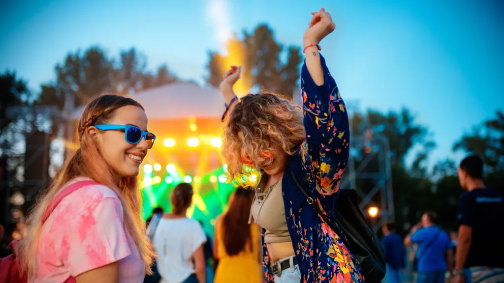 Friends dancing at music festival