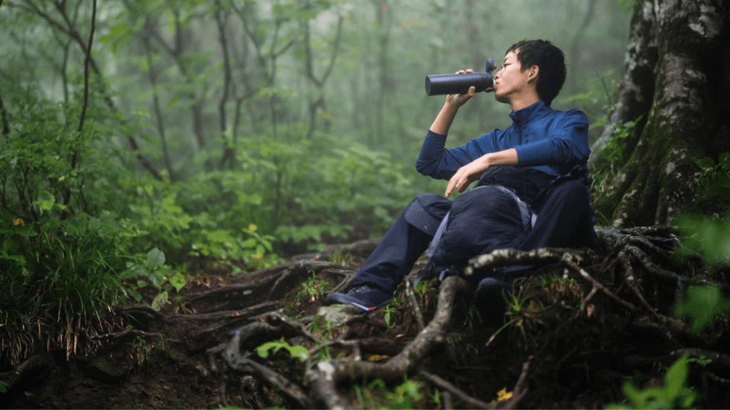 Woman drinking water while hiking in the Great Smoky Mountains