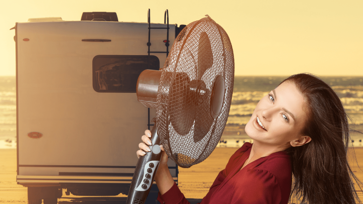Woman using fan in front of RV
