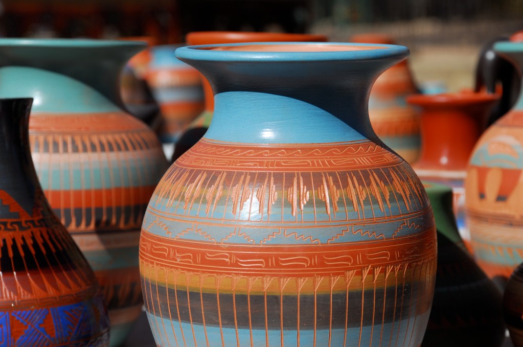 Native American pottery lined up for sale at an outdoor market in Santa Fe, New Mexico.