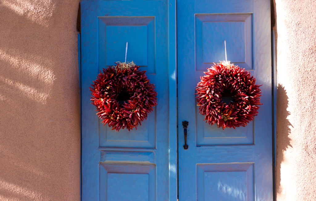 Santa Fe Style: Two Red Ristras hanging on Blue Doors