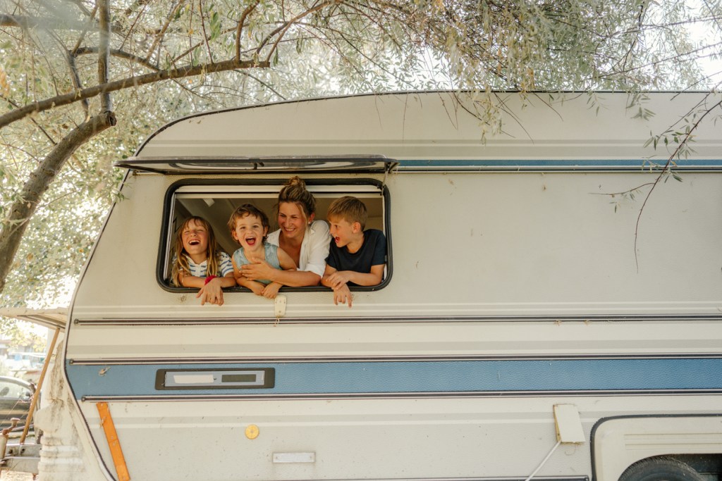A family crowds into the back window of a camper. Is it time to buy a different RV?