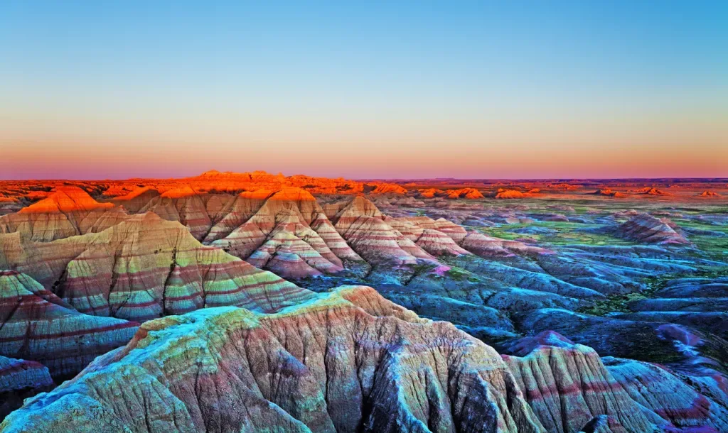 The Wall at sunset. Badlands National Park, South Dakota. Arid landscape, clear sky and moon.