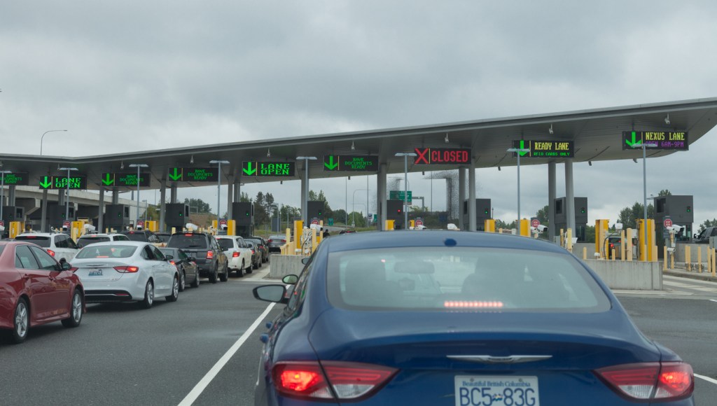 Cars lined up waiting to go through a Canadian border crossing