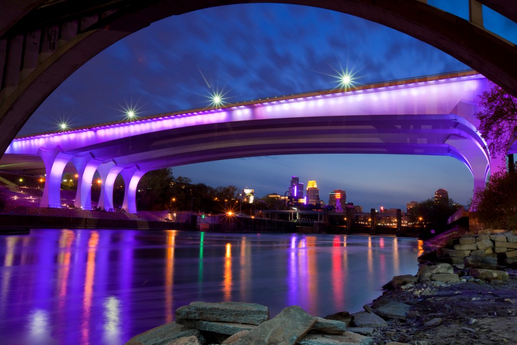 a bridge lit up with purple lights to honor Prince