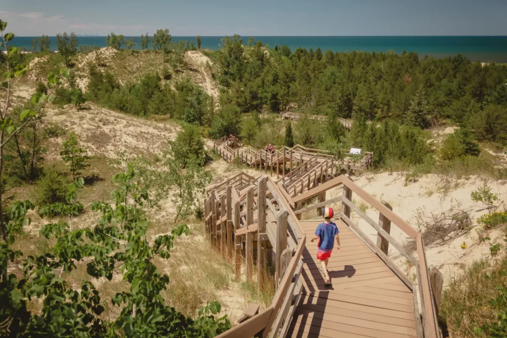 Boy hiking along a sand dune trail in Indiana Dunes National Park.