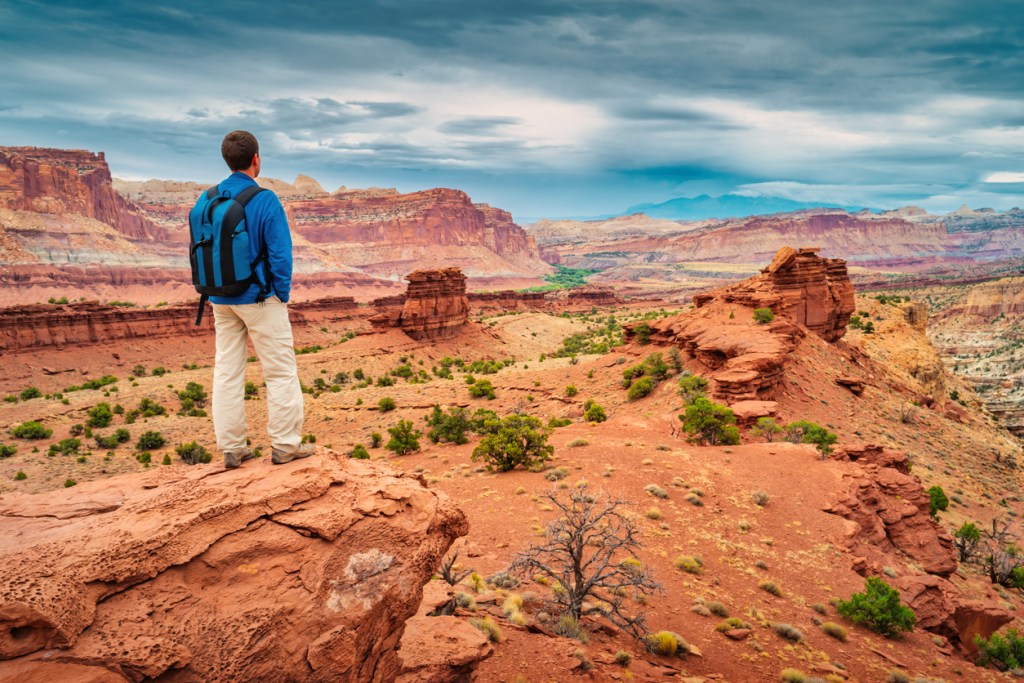Hiker looks at view at Sunset Point in Capitol Reef National Park in Utah, USA.