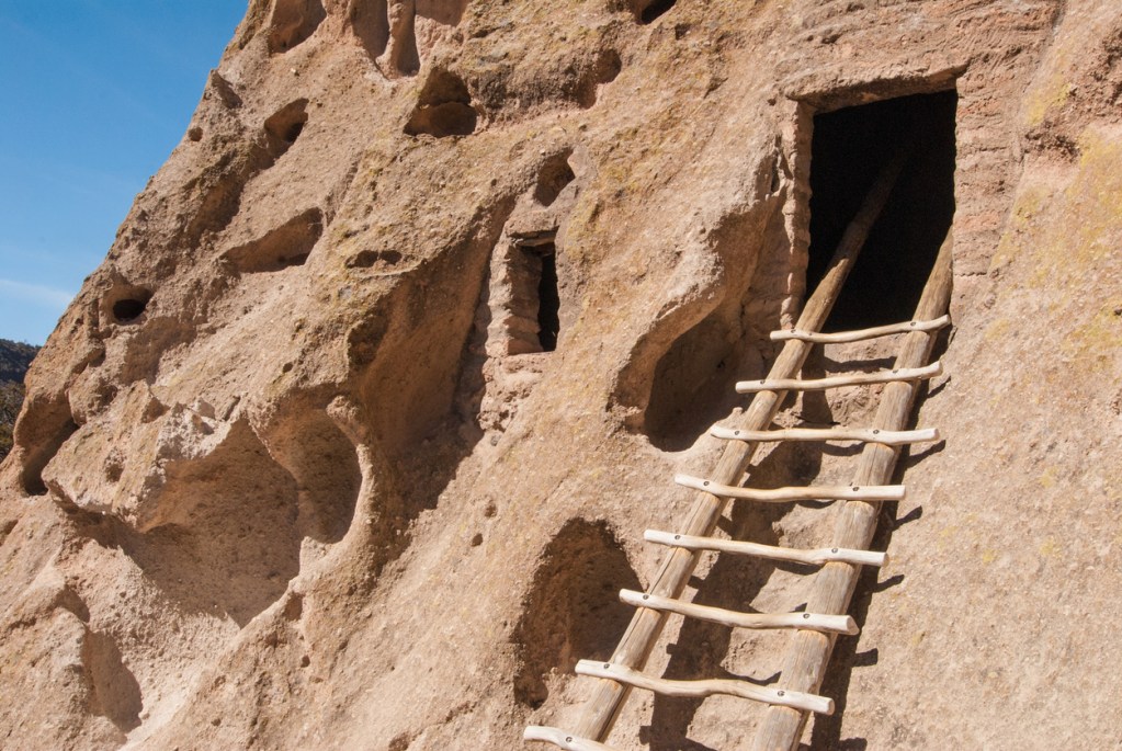 A ladder into a cave entrance at Bandelier National Monument in New Mexico, which is a great day trip from Santa Fe