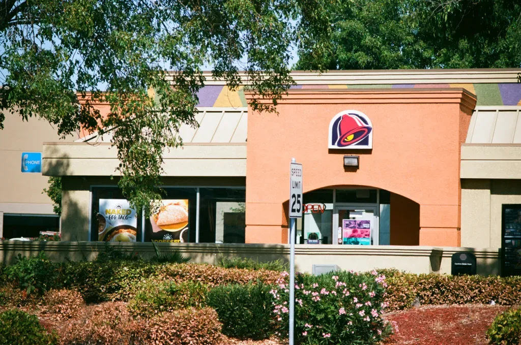 Taco Bell chain Mexican cuisine restaurant set among trees in Concord, California