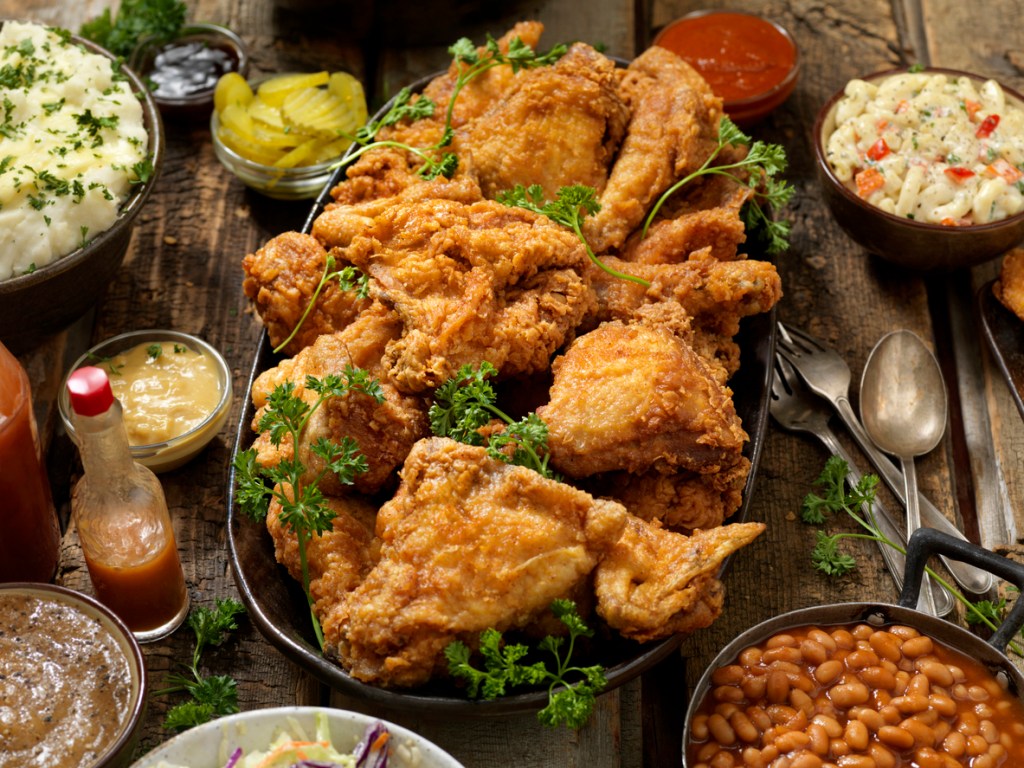 A photo of a fried chicken platter with all the fixings - a popular food in Nashville