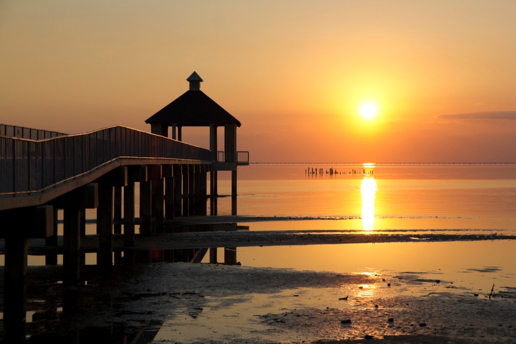 Sunset along Lake Pontchartrain with a gazebo in the foreground. Enjoy this short day trip from New Orleans