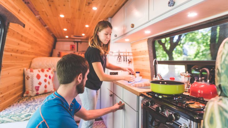 A couple cooking a one-pot meal on their camper