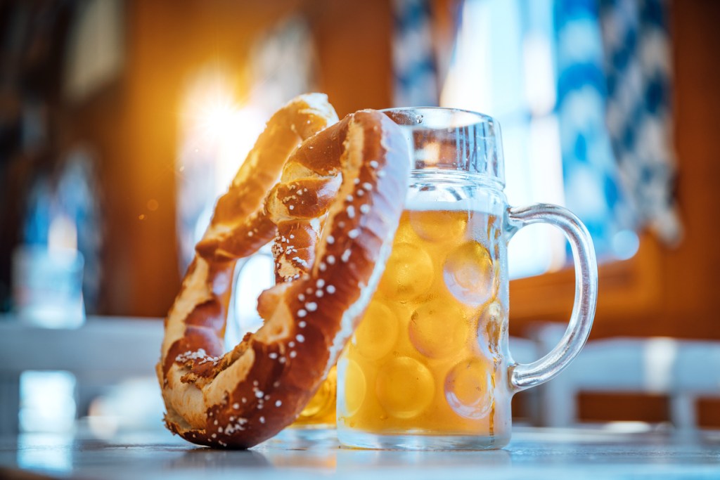 A photo of a soft pretzel and mug of beer. Nothing seems to be more Oktoberfest than beer and pretzels - except maybe the chicken dance