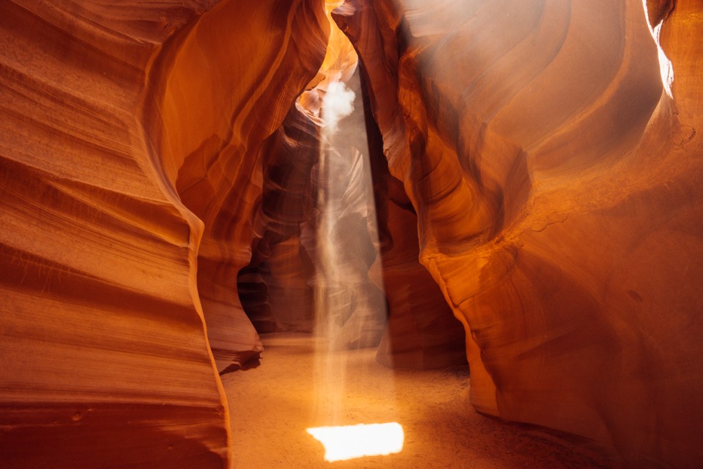 A ray of light shining into a red rock canyon. Could this be the skinwalker portal in Antelope Canyon?
