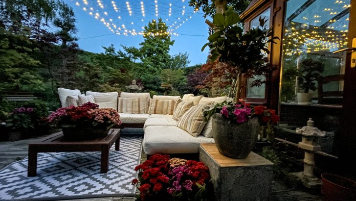 A backyard patio with string lights overhead
