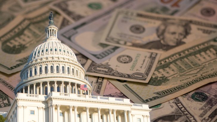 A capitol building with paper money in the background