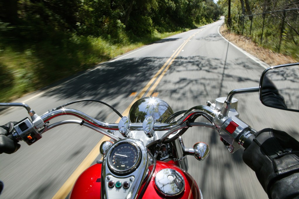 Cruiser motorcycle on a open road from rider point of view. We're talking about some of the best motorcycle roads in Florida.