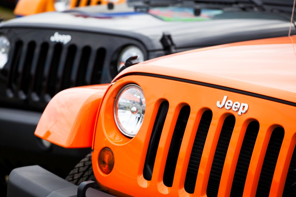 A photo of the front ends of two Jeeps. For some, just owning a Jeep is a badge of honor.
