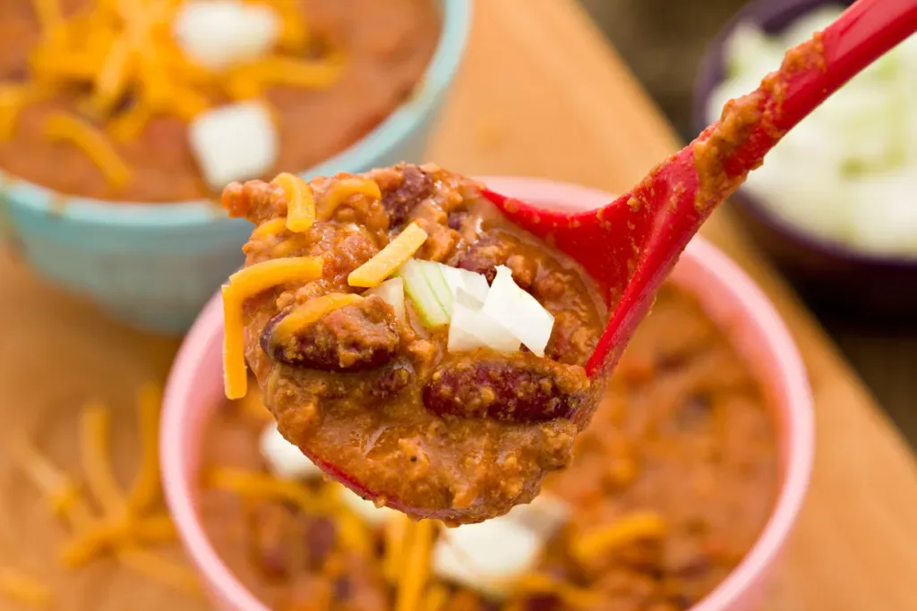 A ladle full of chili, just one of the food choices you'll have at Chomp & Stomp.
