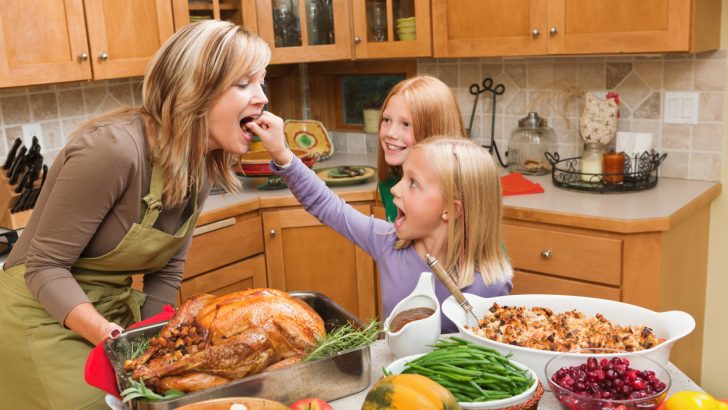 A mother cooking Thanksgiving dinner with two children; did she do it on a budget?