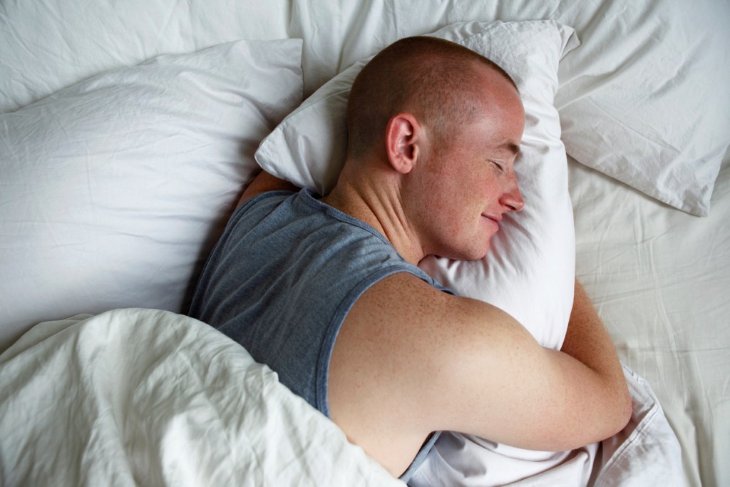 Man hugging a pillow and probably dreaming of boobs