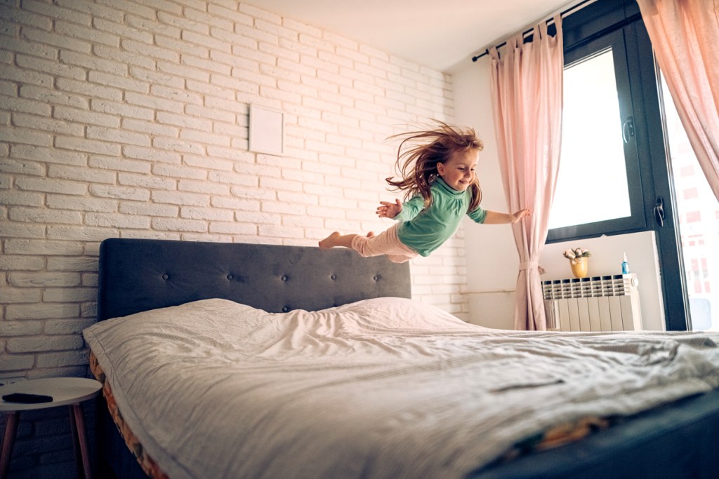 Girl playing in bedroom, jumping on the bed - will the mattress support her weight?
