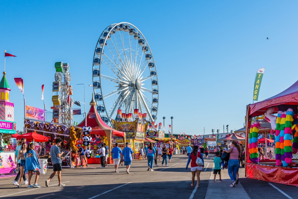 People stroll among the games, rides, and concession stands at the Arizona State Fair in Phoenix.