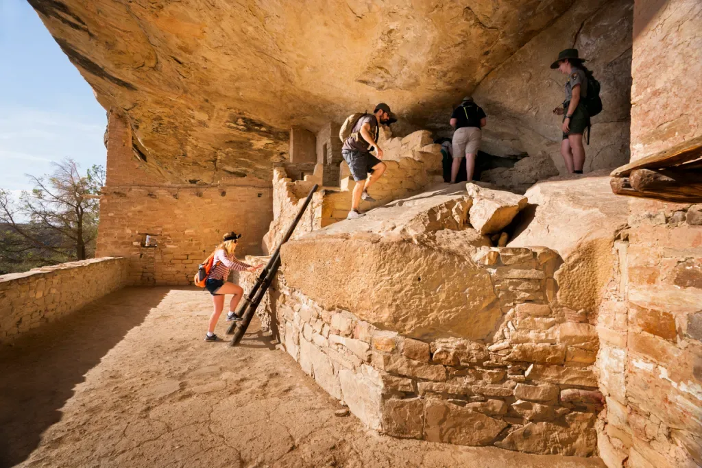 People who may have been camping at Morefield Campground touring an ancient cliff dwelling at Mesa Verde National Park