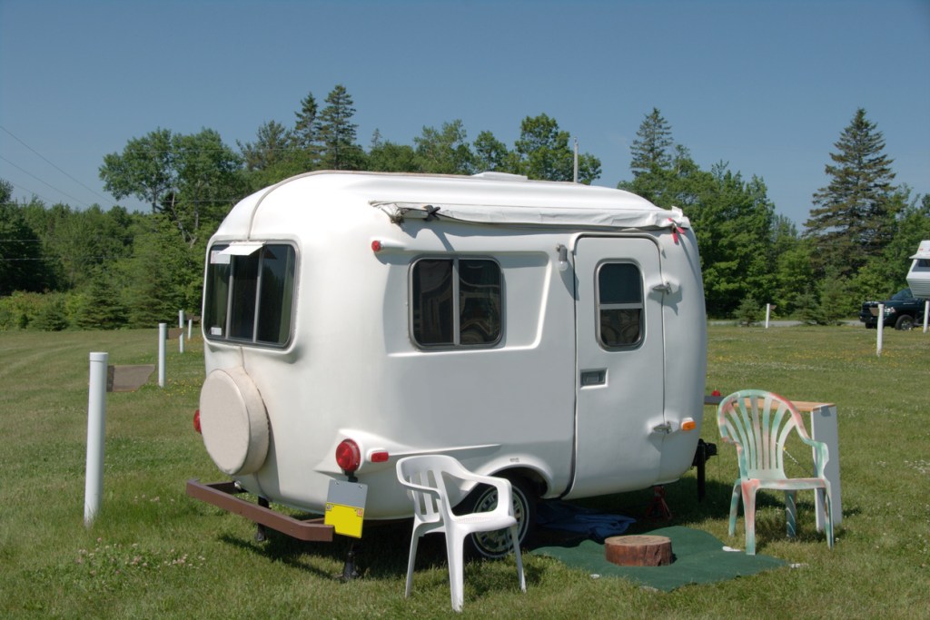 A small or mini travel trailer parked on grass