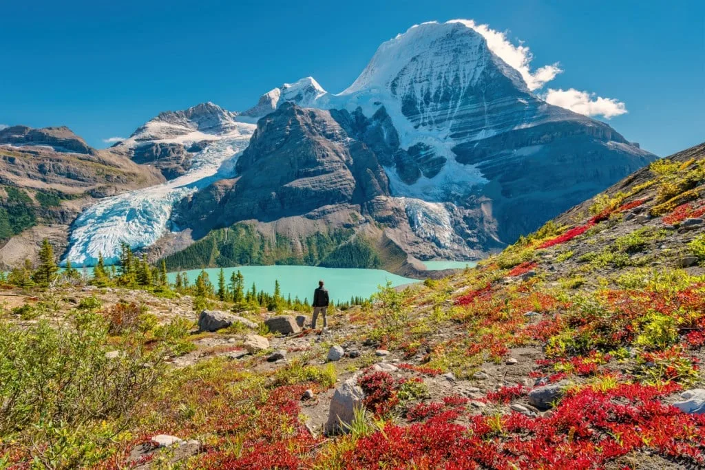 Hiker admires view of Mount Robson from above Berg Lake, Mount Robson Provincial Park, British Columbia, Canada