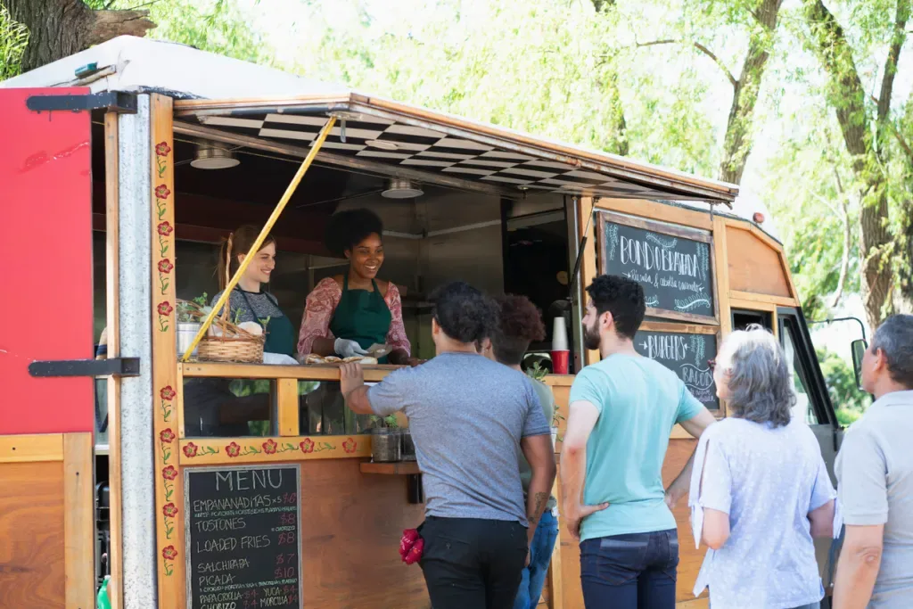 People standing in line at a food truck possibly in Austin, Texas.