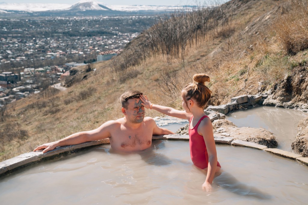 A father and daughter enjoying a natural hot spring