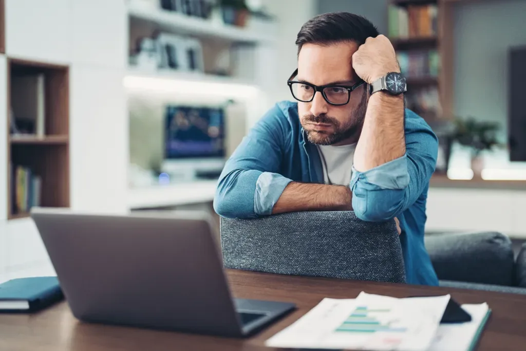 Frustrated man looking at his laptop. He probably could use CampScanner.