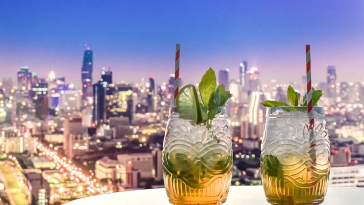 two mojitos in a rooftop bar with a view over Bangkok