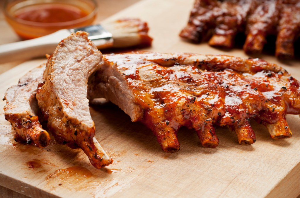 Barbecue ribs with sauce on a cutting board. The Rainforest Cafe's ribs made the 'best' list.
