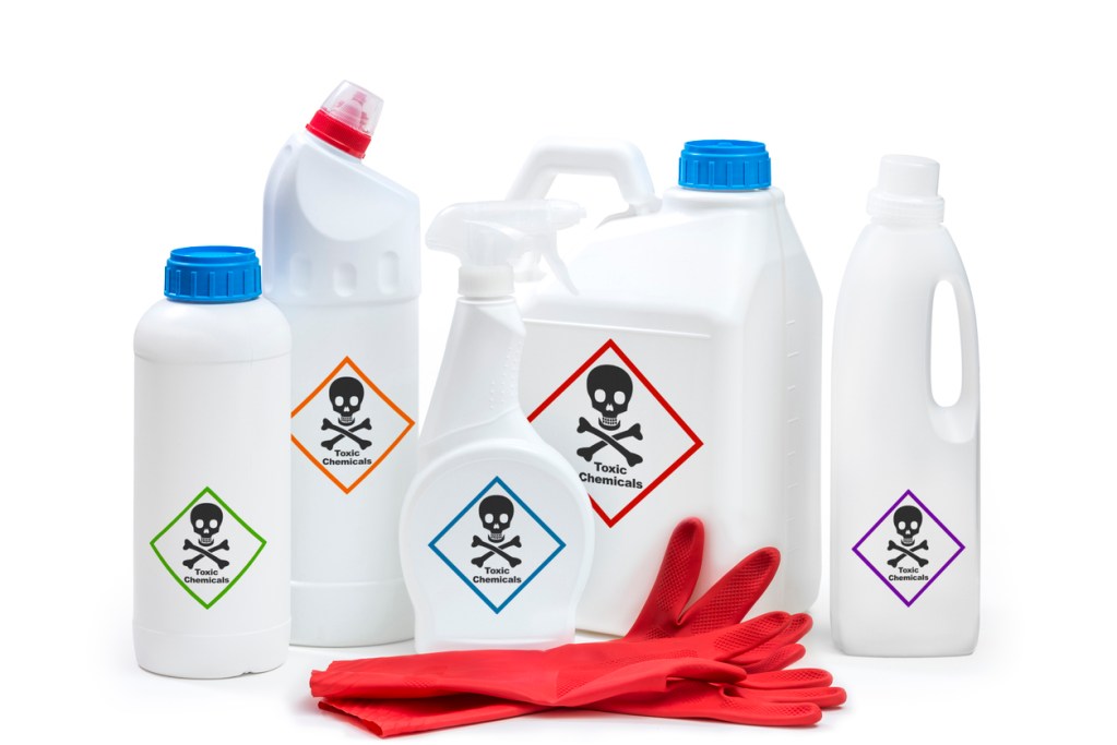 Plastic cleaning bottles with skull and crossbones, toxic chemicals, labels on them. Some household cleaners may increase your risk of cancer.