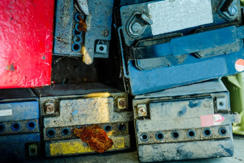 Set of old car batteries waiting to be recycled.