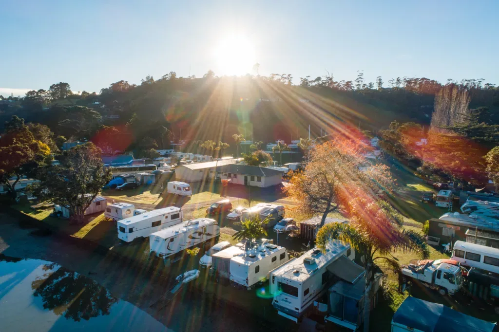 The sun sets behind a full RV park.