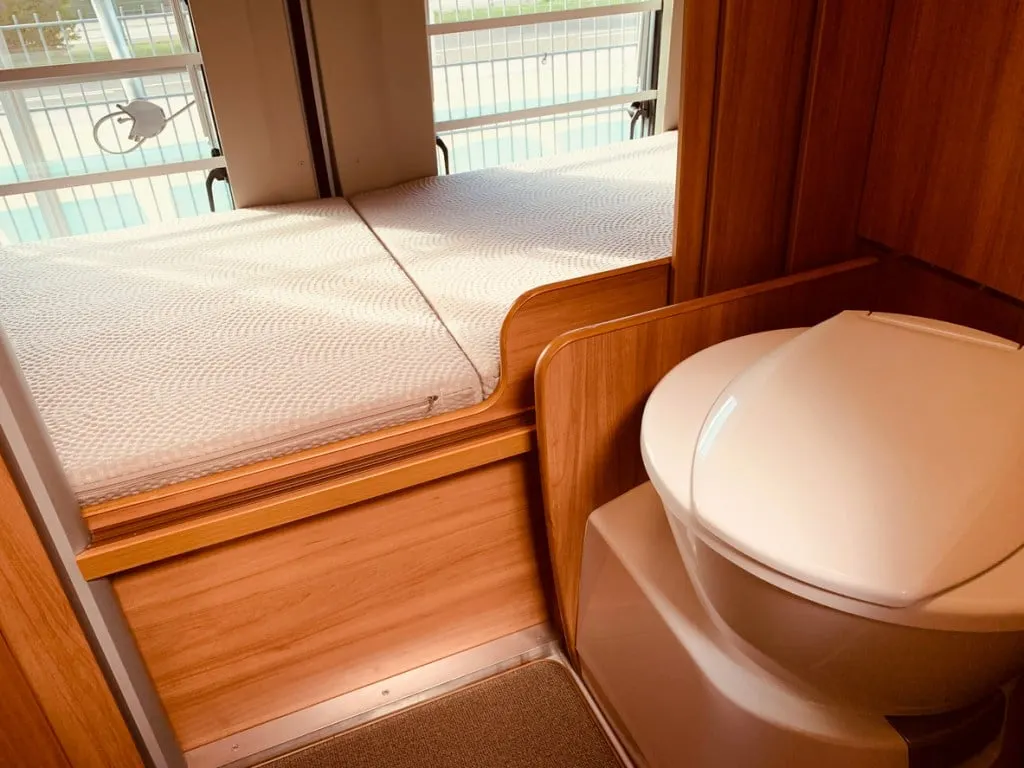 An RV toilet in a nice, clean bathroom. We bet these owners use a black tank treatment to keep their rig fresh on a budget. 
