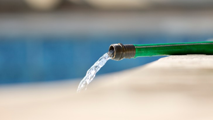 Water rushing out of a standard garden hose, not the kind you should use to fill your freshwater tank.