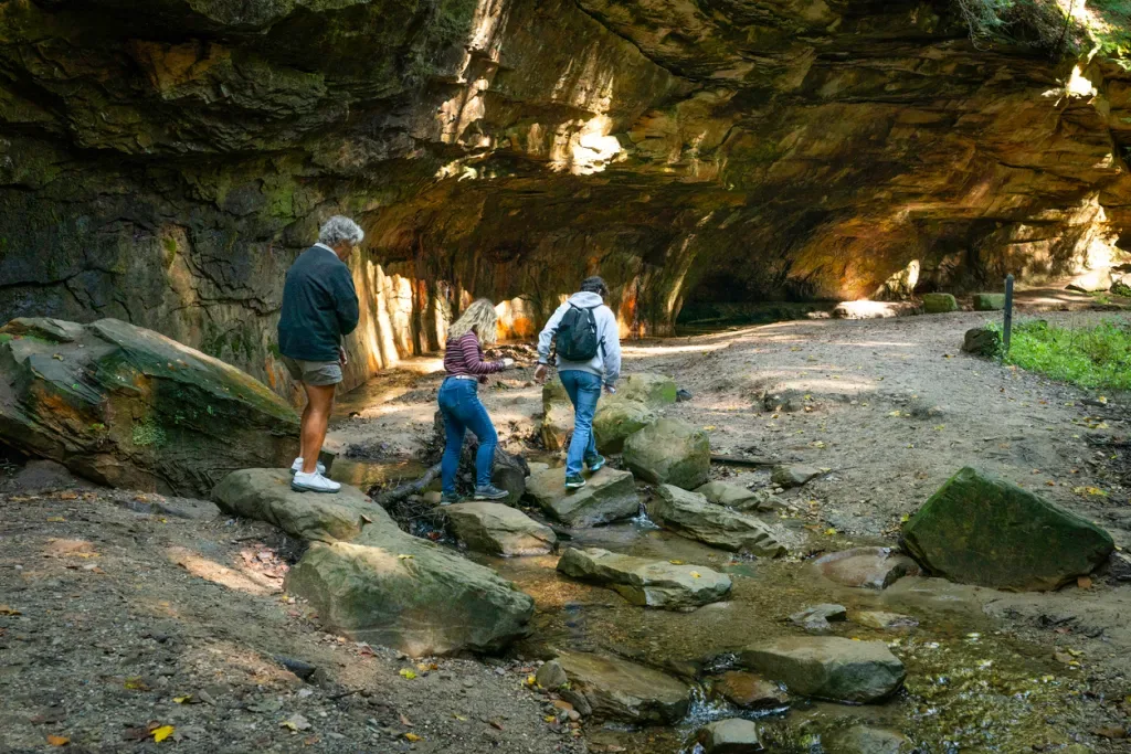 A family of three explore the geological formations of Turkey Creek State Park.