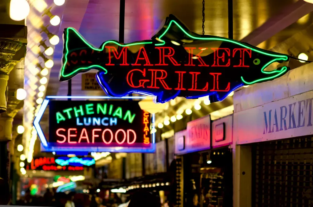 Neon signs at Seattle Public Market. You can expect some of these vendors to appear at Bite of Seattle.