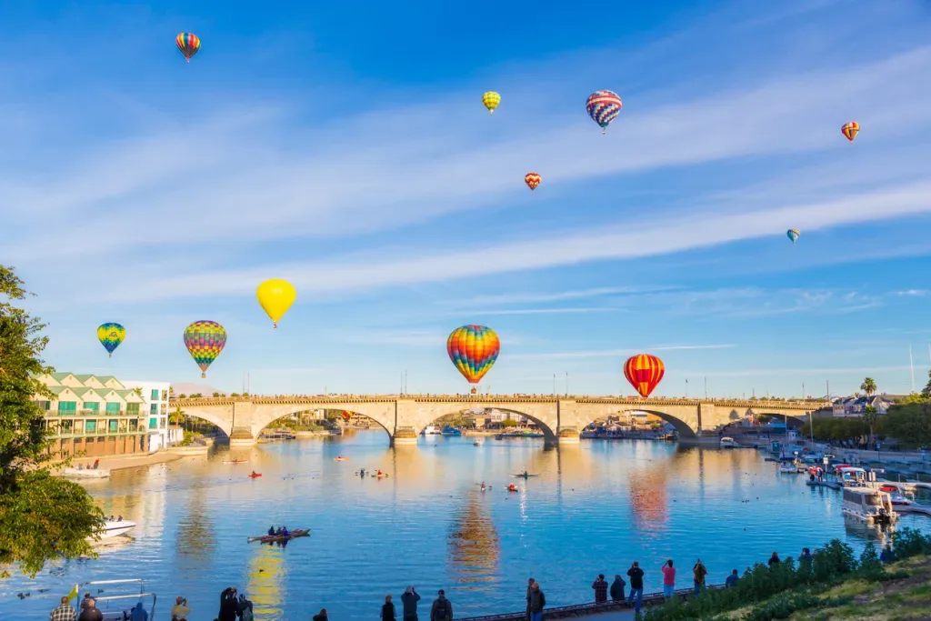 Hot air balloons drift above the London Bridge near Lake Havasu State Park in Arizona.