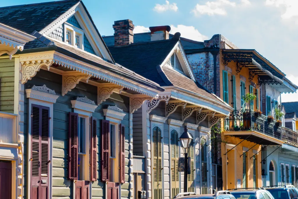 A row of colorful cottages with ornate trimmings in New Orleans.