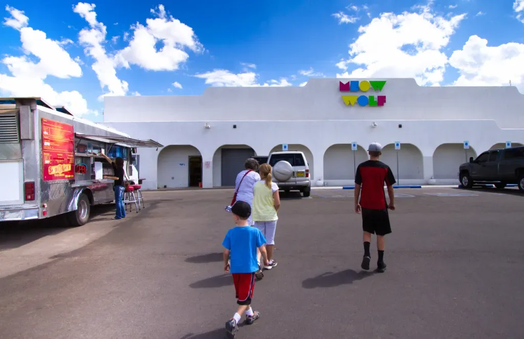 A family walks into Meow Wolf Santa Fe, the original location.