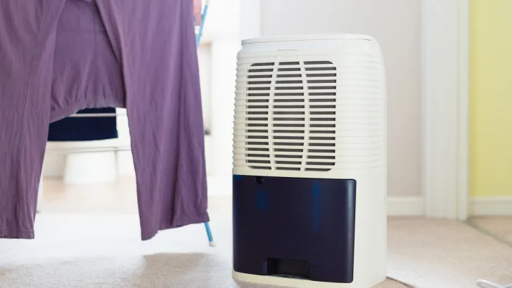 A dehumidifier next to freshly washed laundry.